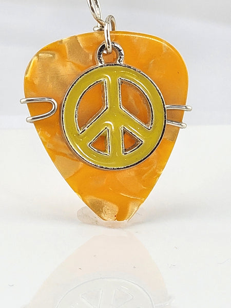 Orange Guitar Pick pendant with yellow peace sign charm.